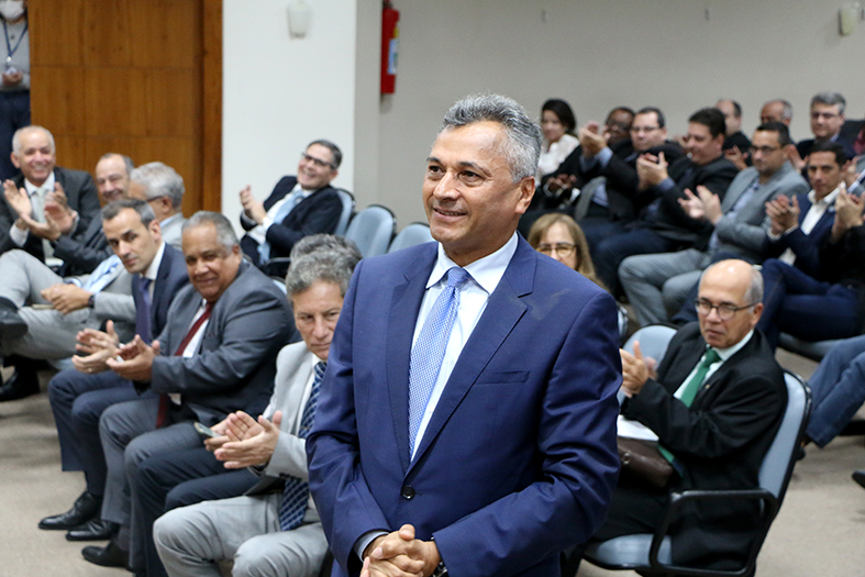 Desembargador Sérgio Ricardo de Souza, home de pele parda com cabelos grisalhos.