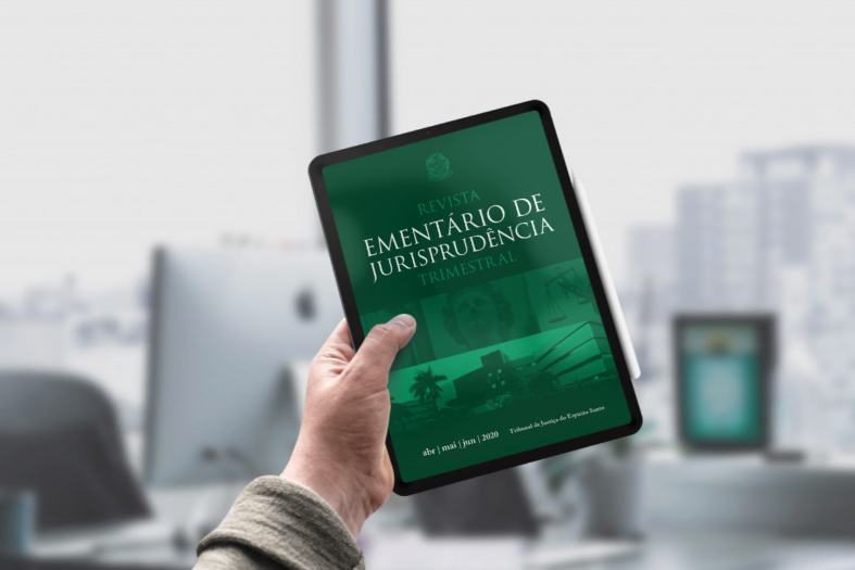 mão de uma pessoa segurando um tablet. na tela a capa da segunda edição da revista ementário do ano de 2020.