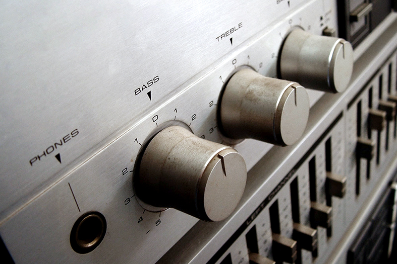 Detalhe de controles de áudio de um som estéreo.